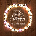Merry Christmas and Happy New Year. Spanish Language. Glowing Lights Wreath for Xmas Holiday Greeting Card Design. Wooden Hand Dr Royalty Free Stock Photo
