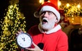 Merry Christmas and Happy new year. Surpised Santa Claus with old clock. Time to celebrate. Royalty Free Stock Photo