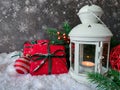 Merry Christmas and Happy New Year. Table decorated with Christmas gifts, holiday decorations and white lantern on snow Royalty Free Stock Photo