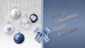 Merry Christmas and happy new year text with blue shiny ribbon bow, decorative glitter tree balls hanging on bokeh lights and snow Royalty Free Stock Photo