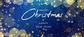 Merry Christmas & Happy New Year Text Design Over Magical Blue Defocused Bokeh Lights and Gold Glitter Background Royalty Free Stock Photo