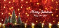 Merry Christmas and happy new year text over xmas tree on red glitter sparkling string lights festive bokeh background.holiday