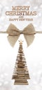 Merry christmas and happy new year text with wooden tree and jut