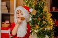 Merry Christmas and happy new year. Thanksgiving day and Christmas. Happy Santa Claus - cute boy child eating a cookie Royalty Free Stock Photo