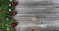 Merry Christmas and Happy New Year theme with holiday decorations on left side of rustic wooden boards Royalty Free Stock Photo