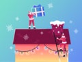 Merry Christmas and Happy New Year Winter Holidays Greetings. Santa Claus Characters Climbing by Ladder on House Roof Royalty Free Stock Photo