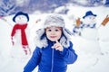 Merry Christmas and Happy new year. Winter portrait of little boy child in snow Garden make snowman. Cute kid - winter Royalty Free Stock Photo