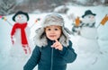 Merry Christmas and Happy new year. Winter portrait of little boy child in snow Garden make snowman. Cute kid - winter Royalty Free Stock Photo