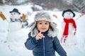Merry Christmas and Happy new year. Winter portrait of little boy child in snow Garden make snowman. Cute kid - winter Royalty Free Stock Photo