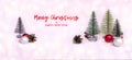 Merry Christmas and happy new year word on pink holiday festive background. Christmas tree, pine cone, red balls at blur Royalty Free Stock Photo