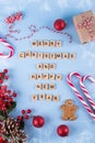 Merry Christmas and happy new year. Words from wooden letters on winter blue background and Christmas decorations. Template, gree Royalty Free Stock Photo