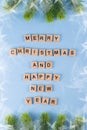 Merry Christmas and happy new year. Words from wooden letters on winter blue background. Template, greeting card. Royalty Free Stock Photo