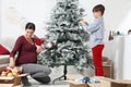 Merry christmas, happy pregnant woman and her child prepare the Christmas tree, open the boxes of balls decorations in the living