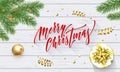 Merry Christmas holiday golden decoration and calligraphy font for greeting card on white wooden background. Vector Christmas or N Royalty Free Stock Photo