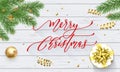 Merry Christmas holiday golden decoration on Xmas tree, calligraphy font for greeting card on white wooden background. Vector Chri Royalty Free Stock Photo