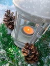 Merry Christmas holiday shiny composition. Burning candle lamp with pine tree on snow