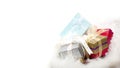 Merry Christmas and Holidays presents and gifts concept with a wrapped gift boxes in christmas sock on snow background Royalty Free Stock Photo