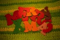 Merry Christmas felt letters on knitted background