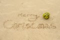 The inscription Merry Christmas on the beach in the sand and coconut Royalty Free Stock Photo