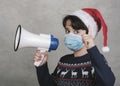 Merry Christmas,kid with medical mask screaming with megaphone