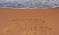 Merry Christmas lettering on the beach. Royalty Free Stock Photo