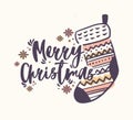 Merry Christmas lettering handwritten with elegant calligraphic script and decorated with knitted stocking or sock and Royalty Free Stock Photo