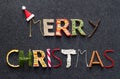 Merry christmas lettering made of various christmas products on dark background
