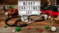 Merry Christmas light box with ornaments and stethoscope Royalty Free Stock Photo