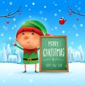 Merry Christmas! Little elf with message board in Christmas snow scene winter landscape Royalty Free Stock Photo