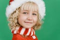 Merry Christmas Little girl in Santa hat on bright green vivid color background Royalty Free Stock Photo