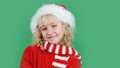 Merry Christmas Little girl in Santa hat on bright green vivid color background Royalty Free Stock Photo