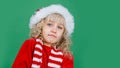 Merry Christmas Little girl in Santa hat on bright green vivid color background Royalty Free Stock Photo