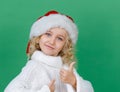 Merry Christmas Little girl in Santa hat on bright green vivid color background Royalty Free Stock Photo