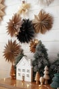 Merry Christmas! Christmas little house, trees, golden lights, paper stars decor. Magic winter time Royalty Free Stock Photo