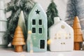 Merry Christmas. Christmas little houses and trees with golden lights bokeh on white background. Festive modern decor. Happy Royalty Free Stock Photo