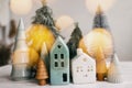 Merry Christmas. Christmas little houses and trees with golden lights bokeh on white background. Festive modern decor. Happy Royalty Free Stock Photo