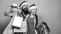Merry christmas. Man and woman shopping. Christmas shopping. Cheerful couple Santa hats hold paper bags. Buy gifts Royalty Free Stock Photo