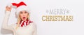 Merry Christmas message with woman with Santa hat Royalty Free Stock Photo