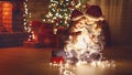 Merry Christmas! mother and child daughter with glowing garland