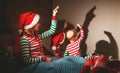 Merry Christmas. mother and children play shadow theater in bed Royalty Free Stock Photo