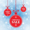 Merry Christmas and New Year balls sale. Red xmas balls with sign sale, special offer. Holiday sale banner on blue Royalty Free Stock Photo