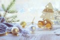 Merry Christmas, New Year decorations, balls, illumination on a light wooden table against the background of a window Royalty Free Stock Photo