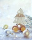 Merry Christmas, New Year decorations, balls, illumination on a light wooden table against the background of a window Royalty Free Stock Photo