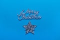 Merry Christmas note star flat lay on a blue background. Winter Holiday greeting gift card