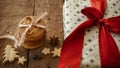 Merry Christmas! Christmas oatmeal cookies and stylish wrapped gift box with red ribbon on rustic wooden table. Xmas healthy
