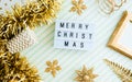 Merry christmas onl lightbox background.top view of sparkling gold tinsel,ball,ornament decorate on green strip line table.holiday