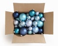 Merry christmas, open cardboard box full of blue turquoise xmas balls, top view isolated on white background, for promotional and Royalty Free Stock Photo