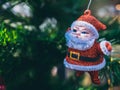 Merry Christmas ornaments, little cute santa claus hanging on green christmas tree background Royalty Free Stock Photo