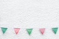 Merry Christmas Party flags bunting hanging on white wall background on x`mas eve holiday event. Minimal hipster style design. Royalty Free Stock Photo