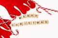 Merry christmas phrase made with wooden letter blocks, candy canes and reindeer antlers